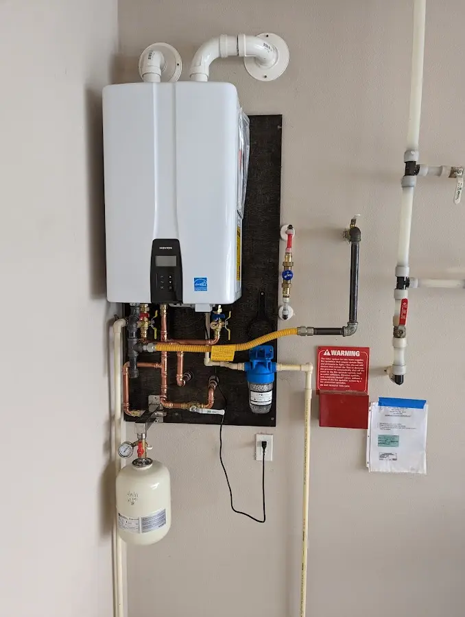 Professional plumber installing copper piping in a Sealy home